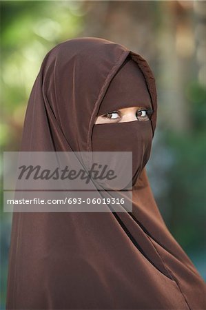 Portarit of young woman in brown niqab