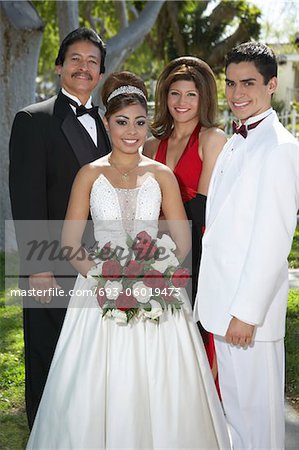 Portrait of couple (13-15) with parents at Quinceanera