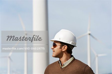 Engineer wearing hardhat at wind farm