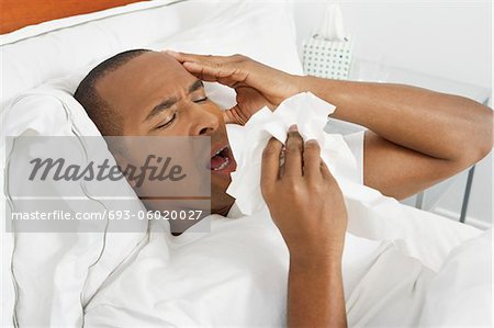 Man with flu in hospital bed