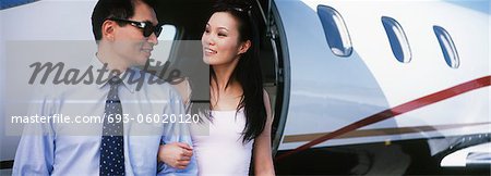Couple exiting private plane
