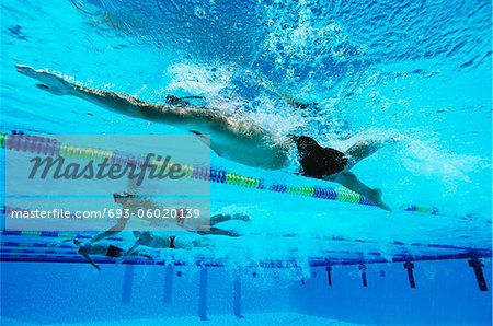 Male swimmers racing in pool, underwater view