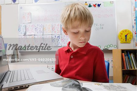 Schoolboy Studying Using a Laptop