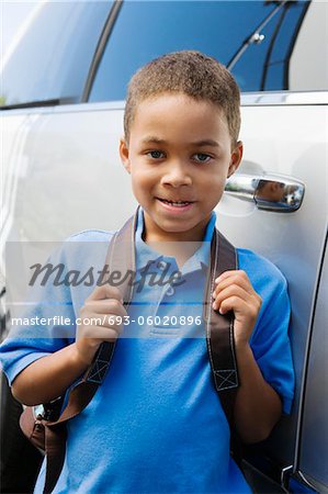 Boy Standing by Minivan