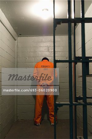 Prisoner standing against the wall