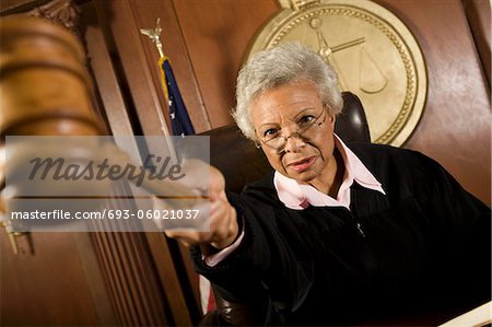 Female judge holding hammer in court