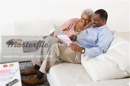 Cheerful Senior Couple Using Laptop