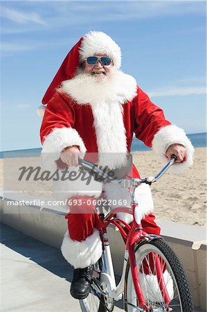 Father Christmas cycles along promenade