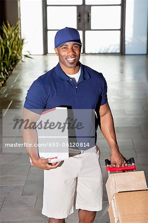 Portrait of a happy delivery man with packages