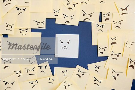 Sticky notes with anthropomorphic face blaming colleague Sticky notes with anthropomorphic face blaming colleague