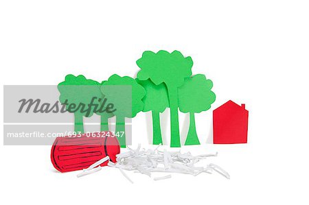 Paper cut outs representing concept of environmental damage over white background