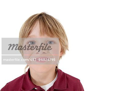 Close-up portrait of a happy school boy over white background