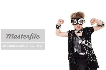 Front view of punk kid wearing pilot goggles with raised fist over white background