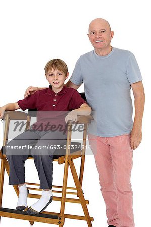 https://image1.masterfile.com/getImage/693-06324814em-portrait-of-senior-man-with-preteen-boy-sitting-on-directors-chair.jpg