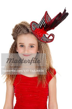 Portrait of happy girl in red outfit and hat over white background
