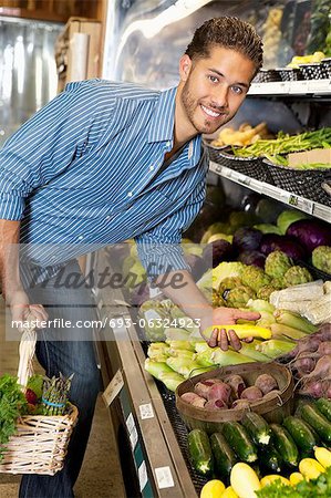 Portrait of a happy man shopping for vegetables in market