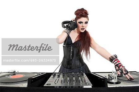 Portrait of beautiful young DJ listening to music over white background Portrait of beautiful young DJ listening to music over white background