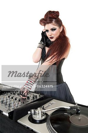 Beautiful DJ with sound mixing equipment over white background