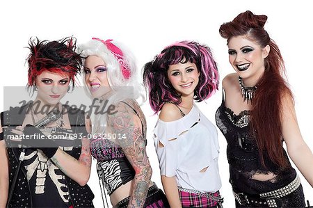 Portrait of all female rock band with microphone over white background