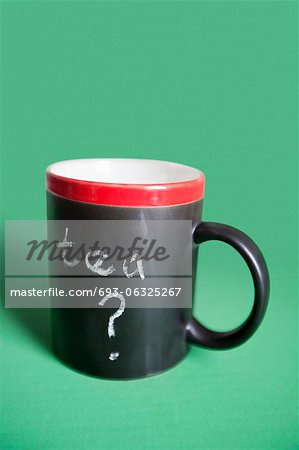 Close-up of coffee mug with text over colored background