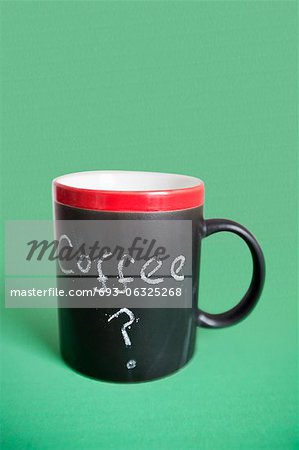 Close-up of coffee cup with text over colored background