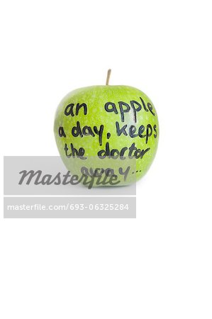 Close-up of sayings text on a juicy granny smith apple over white background