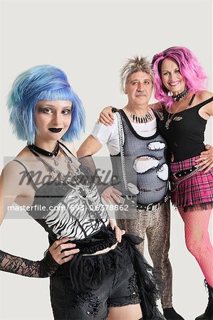 Group portrait of young female punk with senior couple standing in background