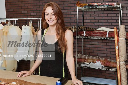 Portrait of beautiful young female dressmaker smiling