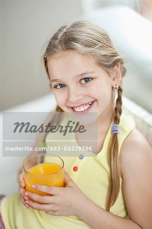 Portrait of girl drinking orange juice