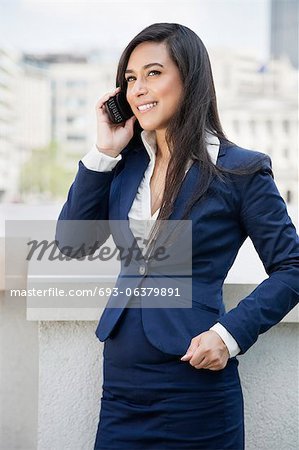 Young Indian businesswoman using cell phone