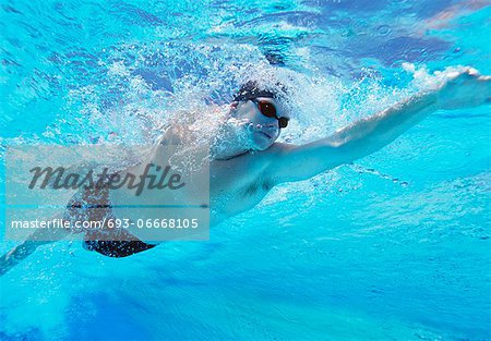 Underwater shot of professional male athlete swimming in pool