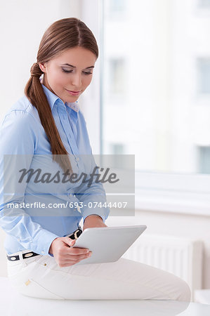 Beautiful businesswoman using tablet computer
