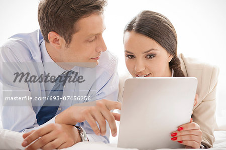 Business couple using digital tablet in hotel