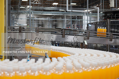 Packed bottles moving on conveyor belt Packed bottles moving on conveyor belt