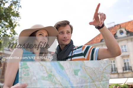 Young tourist couple with map outdoors