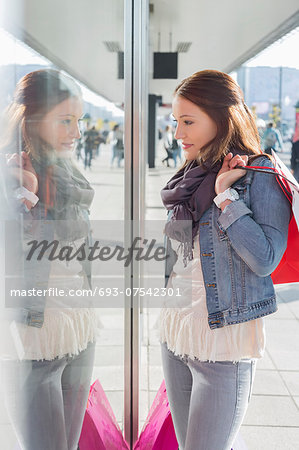 Young woman in casuals window shopping Young woman in casuals window shopping