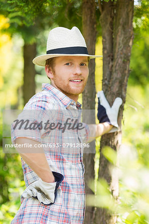 Portrait of confident gardener standing at plant nursery