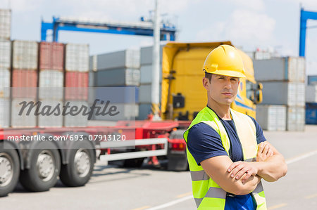 Portrait of confident mid adult man in shipping yard