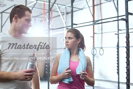 Man and woman looking at each other in crossfit gym