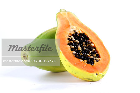 Halved papaya on white background