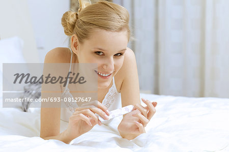 Young woman filing her nails