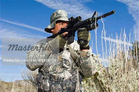 Soldier aiming machine gun