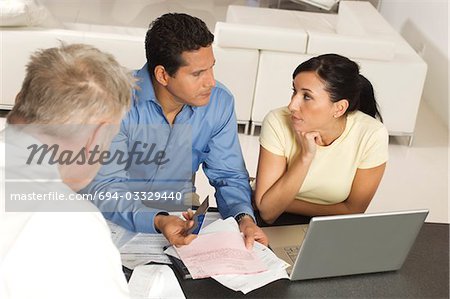 Businessman Assisting Couple with Credit Cards