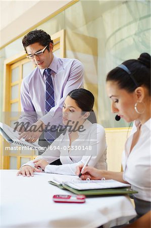 Three colleagues working in business meeting