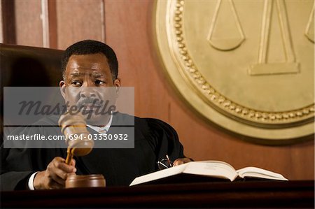 Middle-aged judge holding gavel