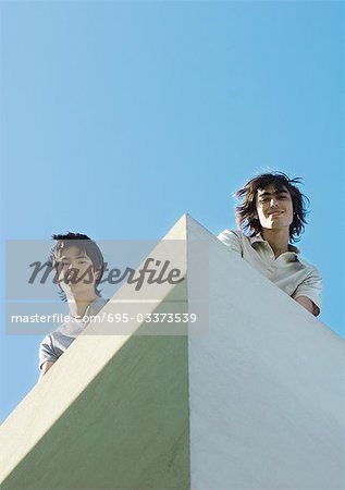 Two young men, low angle view with sky in background