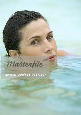 Woman in water, looking at camera
