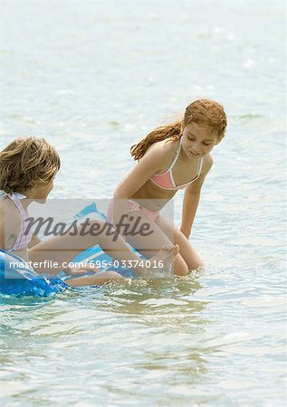 Girls sitting on air mattress together