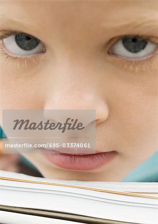 Girl resting chin on notebook