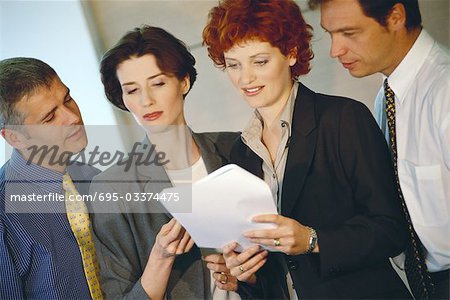 Business associates looking at document